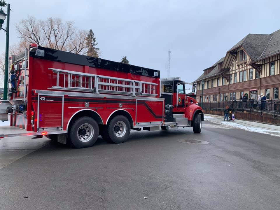Red tanker water truck, Fire truck in front of train station